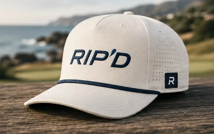 Cream RIP’D rope hat on a wooden table by the coast